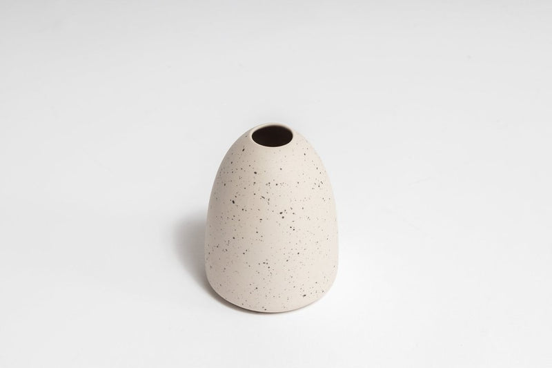 A Little Rick Vase by Ned Collections on a white surface.