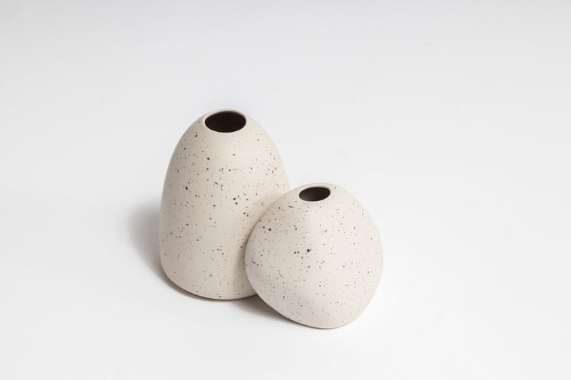 Two hand-crafted feel HARMIE Pebble Vases created by Vietnamese Artisans on a white surface. (Brand: Ned Collections)