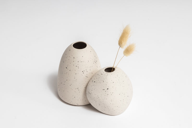 A pair of Ned Collections HARMIE Pebble Vase - Natural white vases with a hand-crafted feel, created by Vietnamese artisans and adorned with dried flowers.