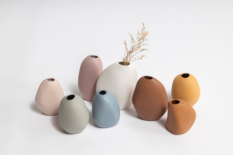 A group of Harmie Vase - Pod - White vases by Ned Collections, with a modern colour palette on a white surface.