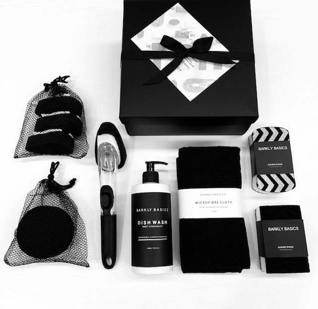 A minimalist black and white gift box with various items, including a Barkly Basics Microfibre Tea Towel - Black.