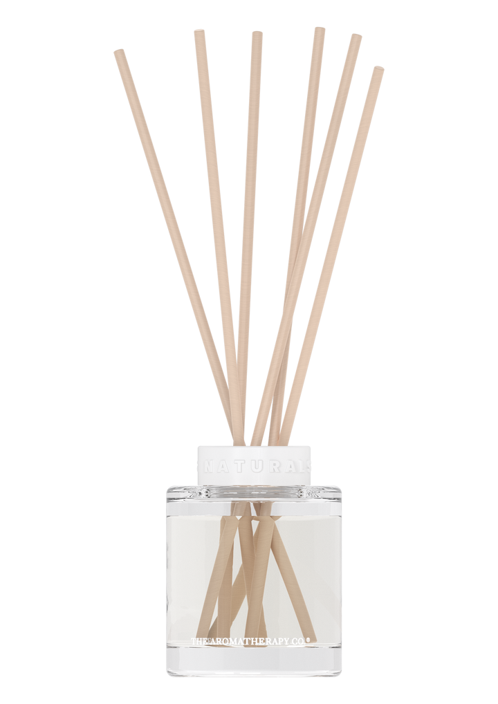 Naturals reed diffuser in a small clear glass bottle with pale reeds