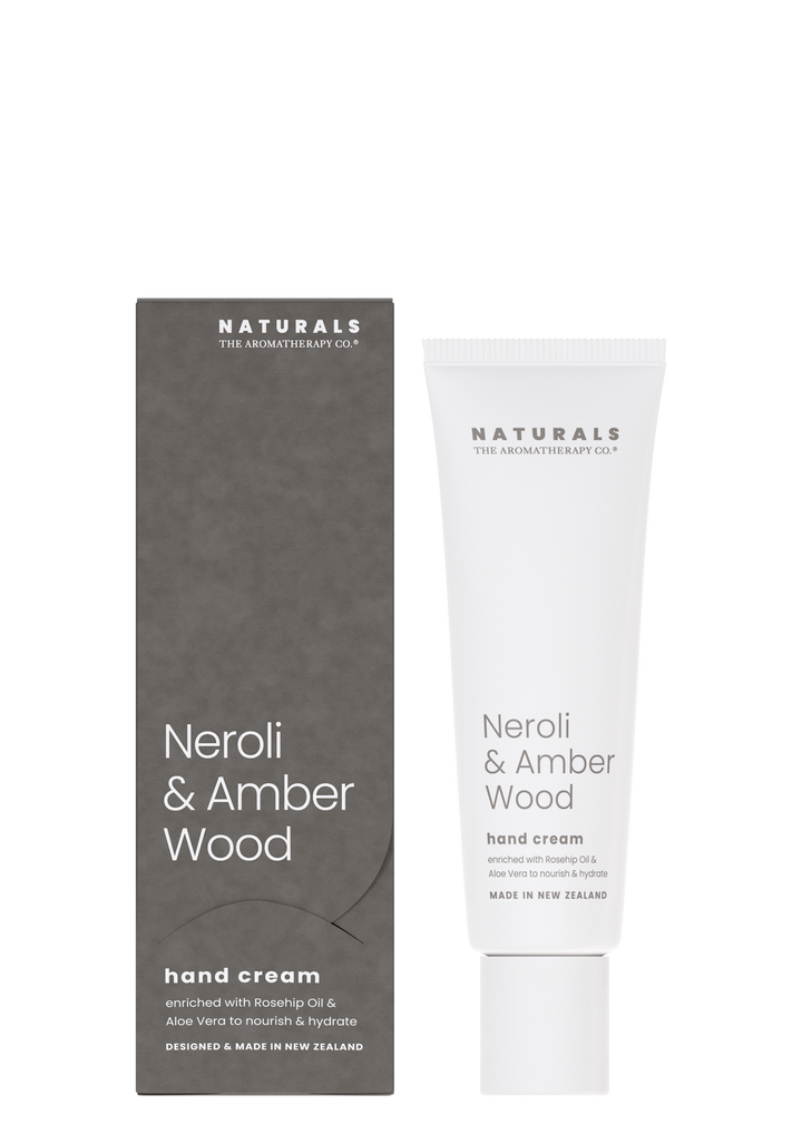 Naturals Neroli & Amber Wood hand cream tube beside its grey box on a white background