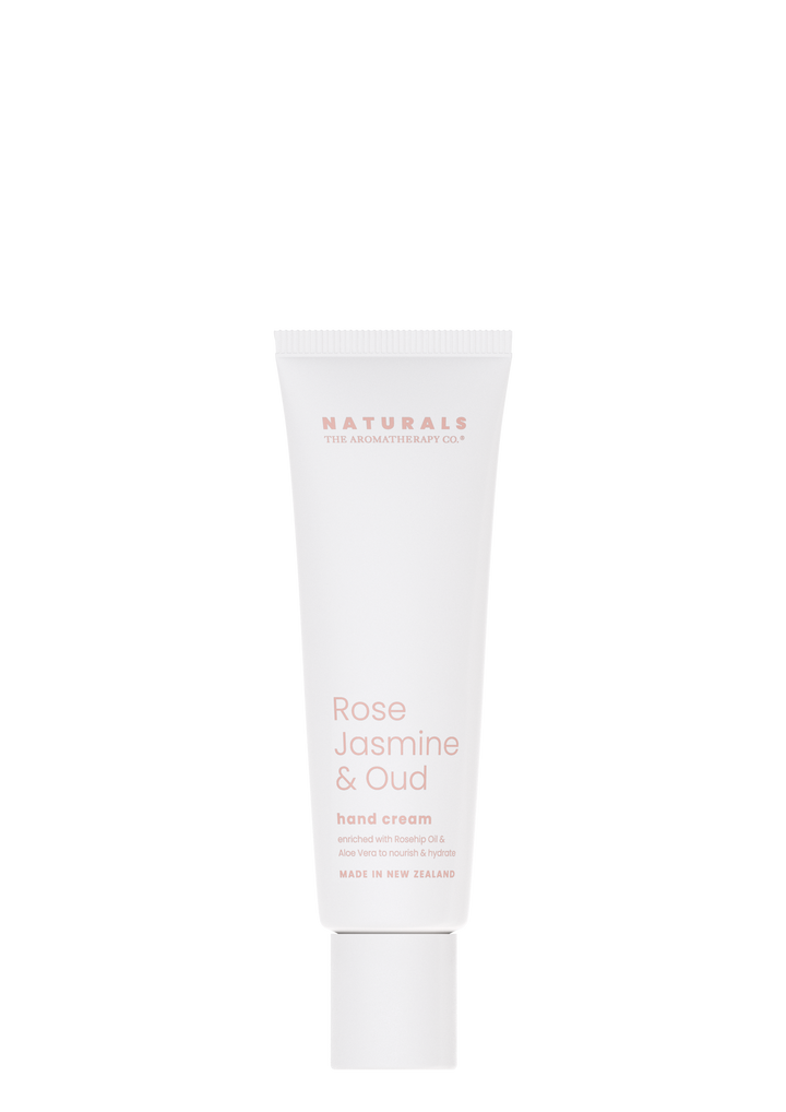 Naturals Rose Jasmine & Oud hand cream in a white tube on a white background