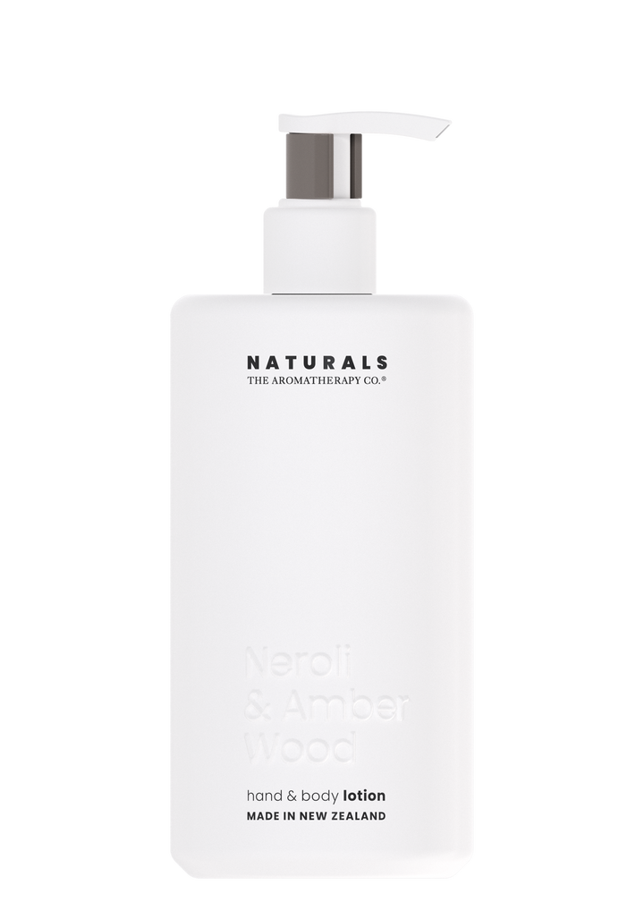 Naturals Neroli & Amber Wood hand and body lotion in a white pump bottle on a white background