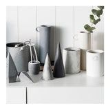 A collection of Zakkia's Concrete Cone - Ink vases with ink marbled designs on a white shelf.