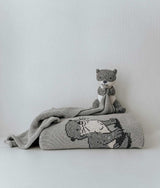 A cozy grey SEA OTTER SNUGGLY blanket with a teddy bear on it, made from Oeko-tex Certified Cotton by Bengali Collections.