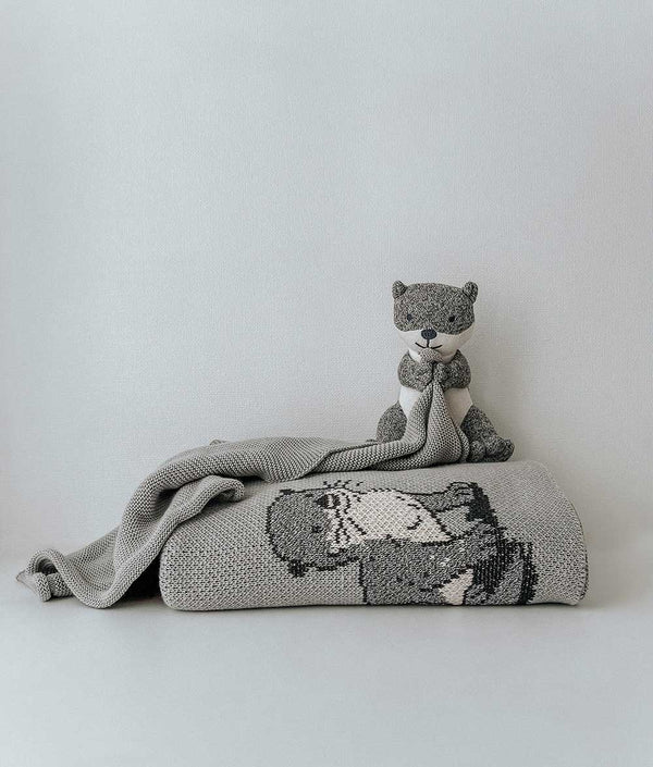 A cozy grey SEA OTTER SNUGGLY blanket with a teddy bear on it, made from Oeko-tex Certified Cotton by Bengali Collections.