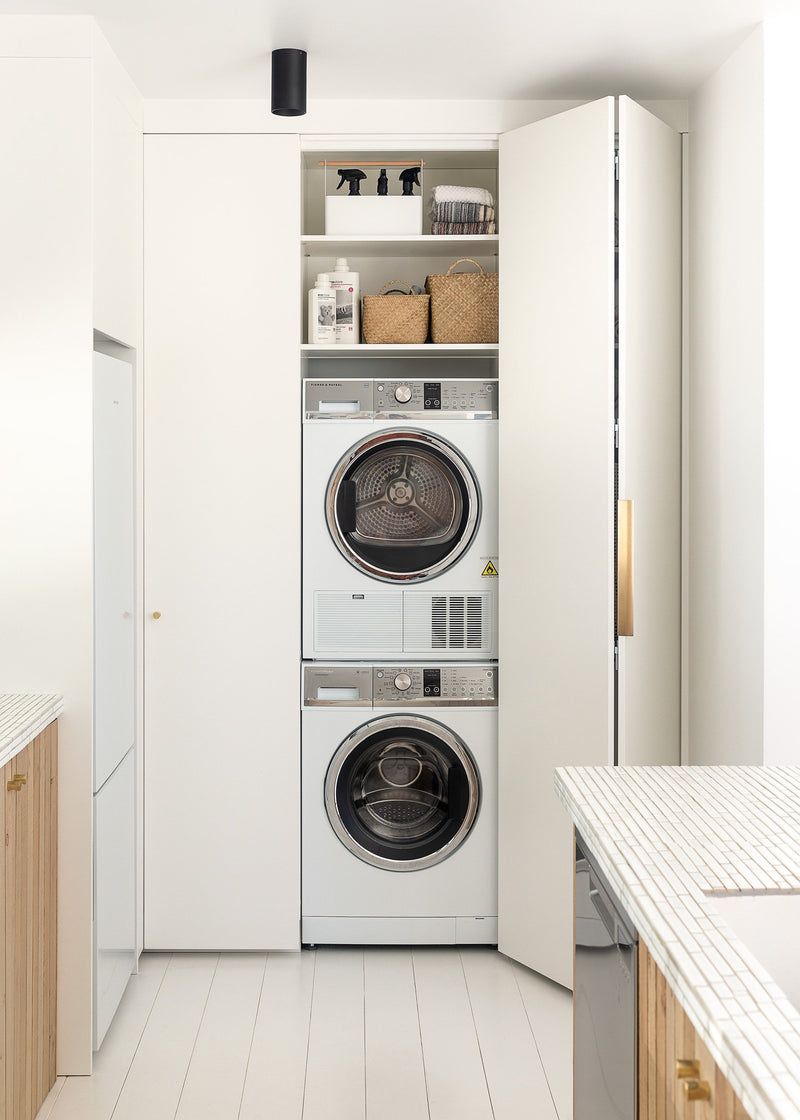 A laundry room with a Our Spaces - Contemporary New Zealand Interiors washer and dryer.