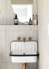 A bathroom with a sink and mirror from Our Spaces - Contemporary New Zealand Interiors by Books.