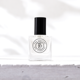 A bottle of The Perfume Oil Collection Gift Set - Fresh by The Perfume Oil Company sitting on top of a white surface.