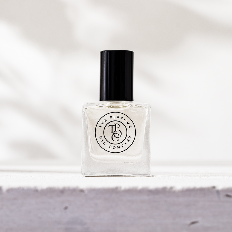 Perfume oil bottle on a pale stone ledge in bright light