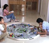 Kids engaging in imaginative play with a Play Pouch Wow Town Track Interactive in a living room.