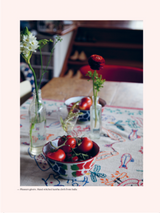 A Victoria Alexander home table with two bowls of tomatoes on it.