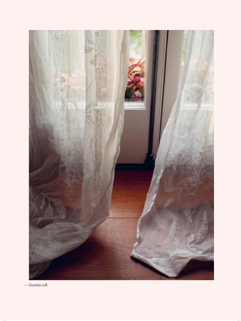Home book page spread showing a curtain in a window
