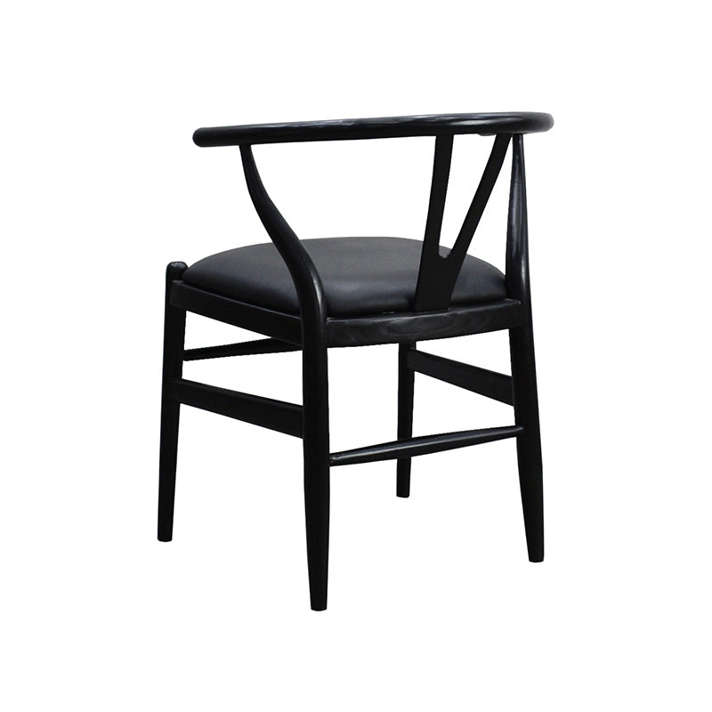 Wishbone chair angled to the left, showing the rounded arm rail and braced legs