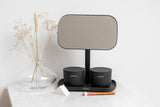 A bathroom with a Flux Home MIRROR WITH STORAGE TRAY - Dark Grey / White and a vase next to it, perfect for applying make-up.