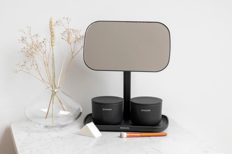 A bathroom with a Flux Home MIRROR WITH STORAGE TRAY - Dark Grey / White and a vase next to it, perfect for applying make-up.