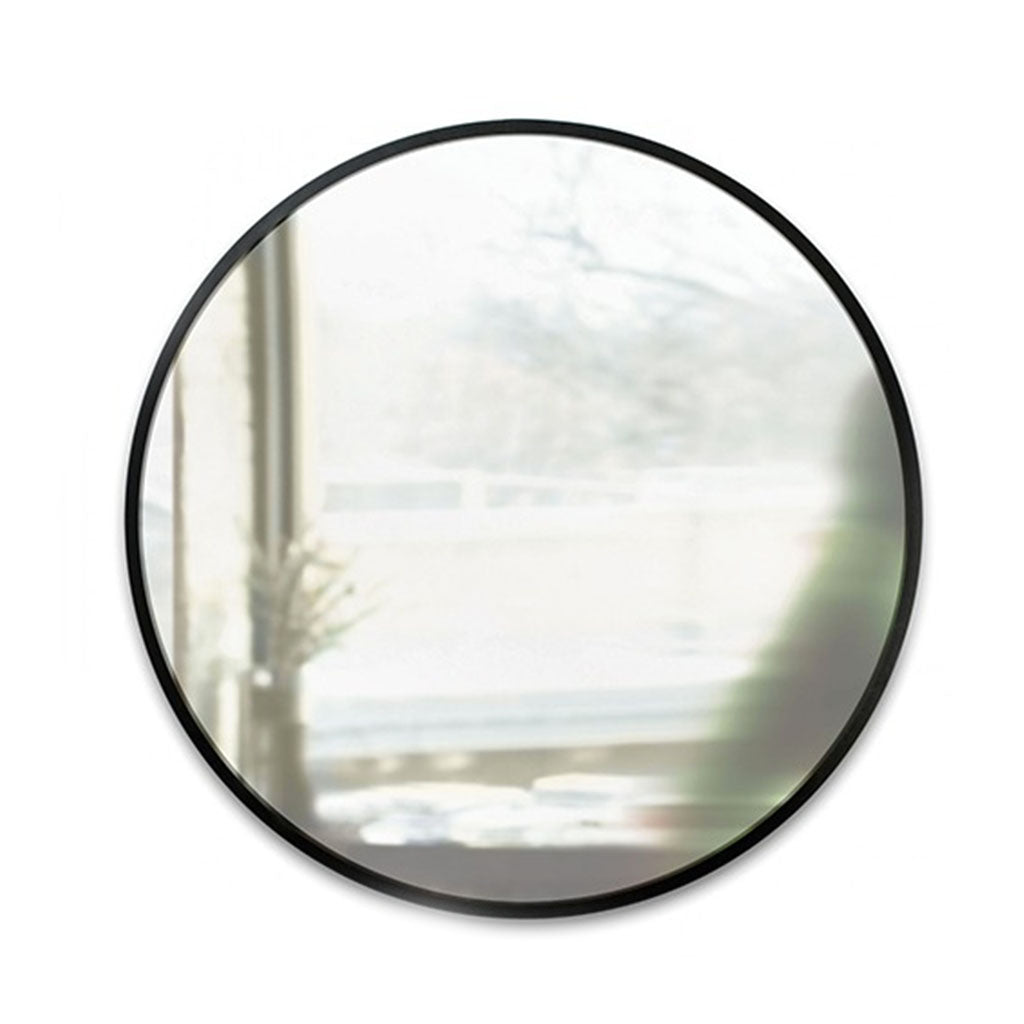 Umbra Hub 60cm round mirror with black rubber frame on wall