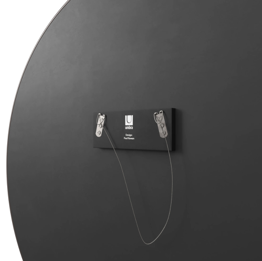 Back of the Umbra Hubba round mirror in titanium, showing the hanging hardware