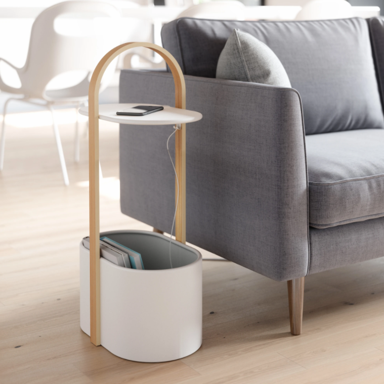 Umbra Bellwood storage table in white and natural beside a grey sofa, phone on the tabletop