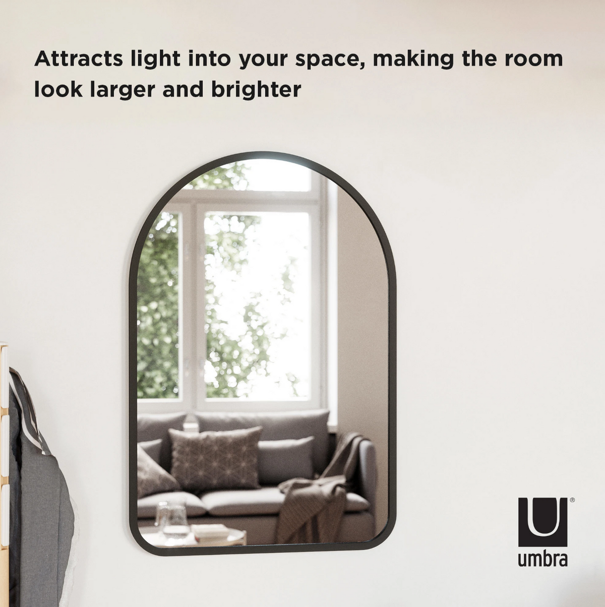 Umbra Hub arched mirror 61x91cm black leaning against a wall