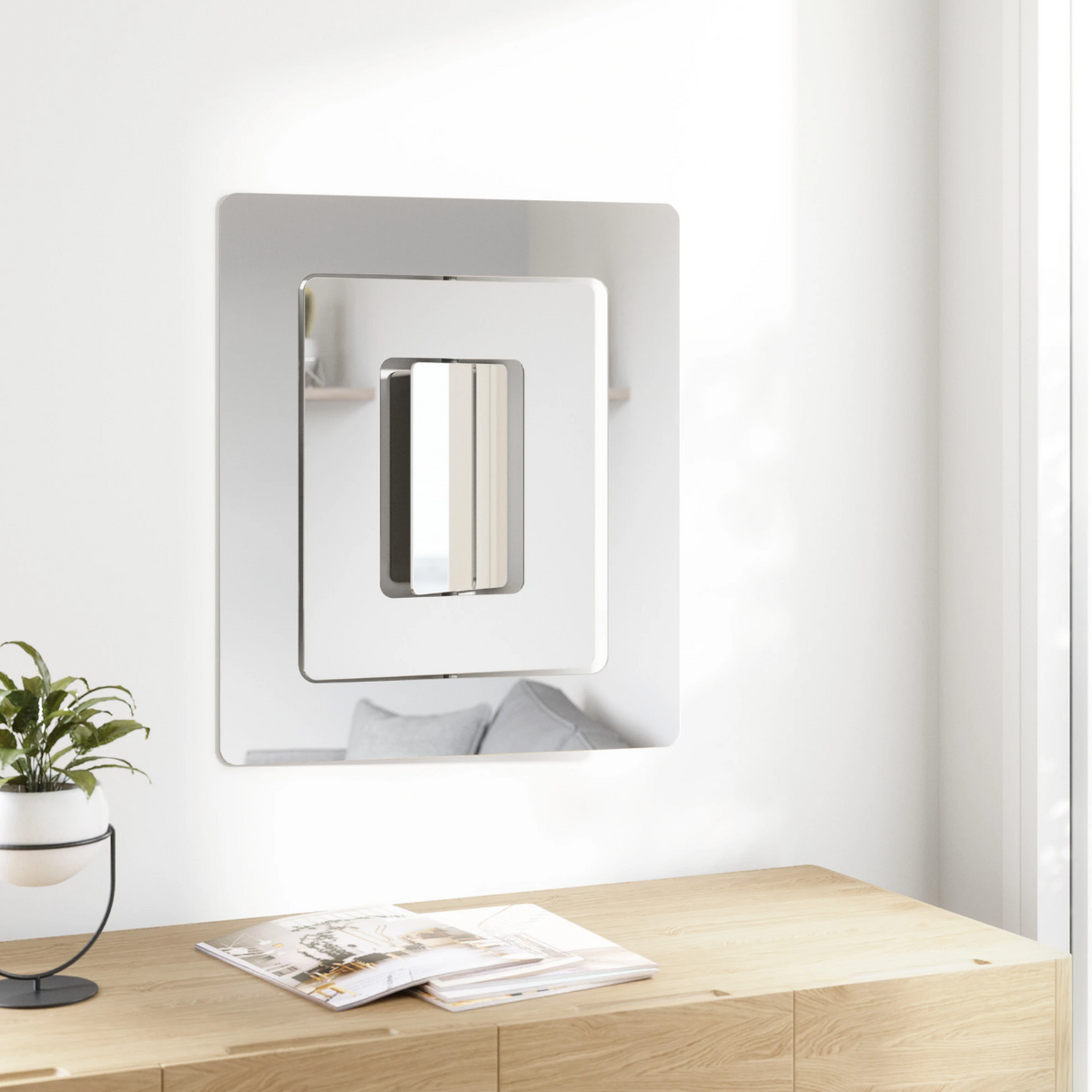 Umbra Echo three-part wall mirror on a white wall above a timber bench