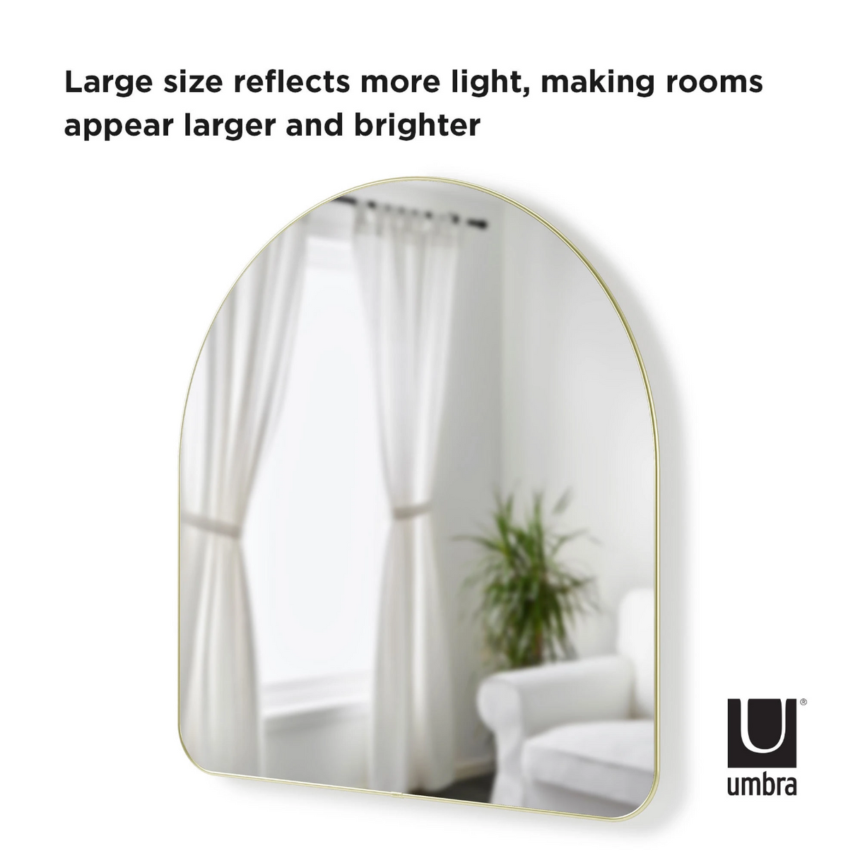 Umbra Hubba arched mirror in brass, large size that reflects more light