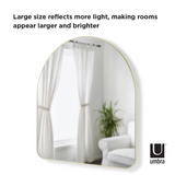 A HUBBA ARCHED MIRROR - BRASS from Umbra with a metallic finish rim adds a decorative touch to rooms, making them appear larger and brighter.