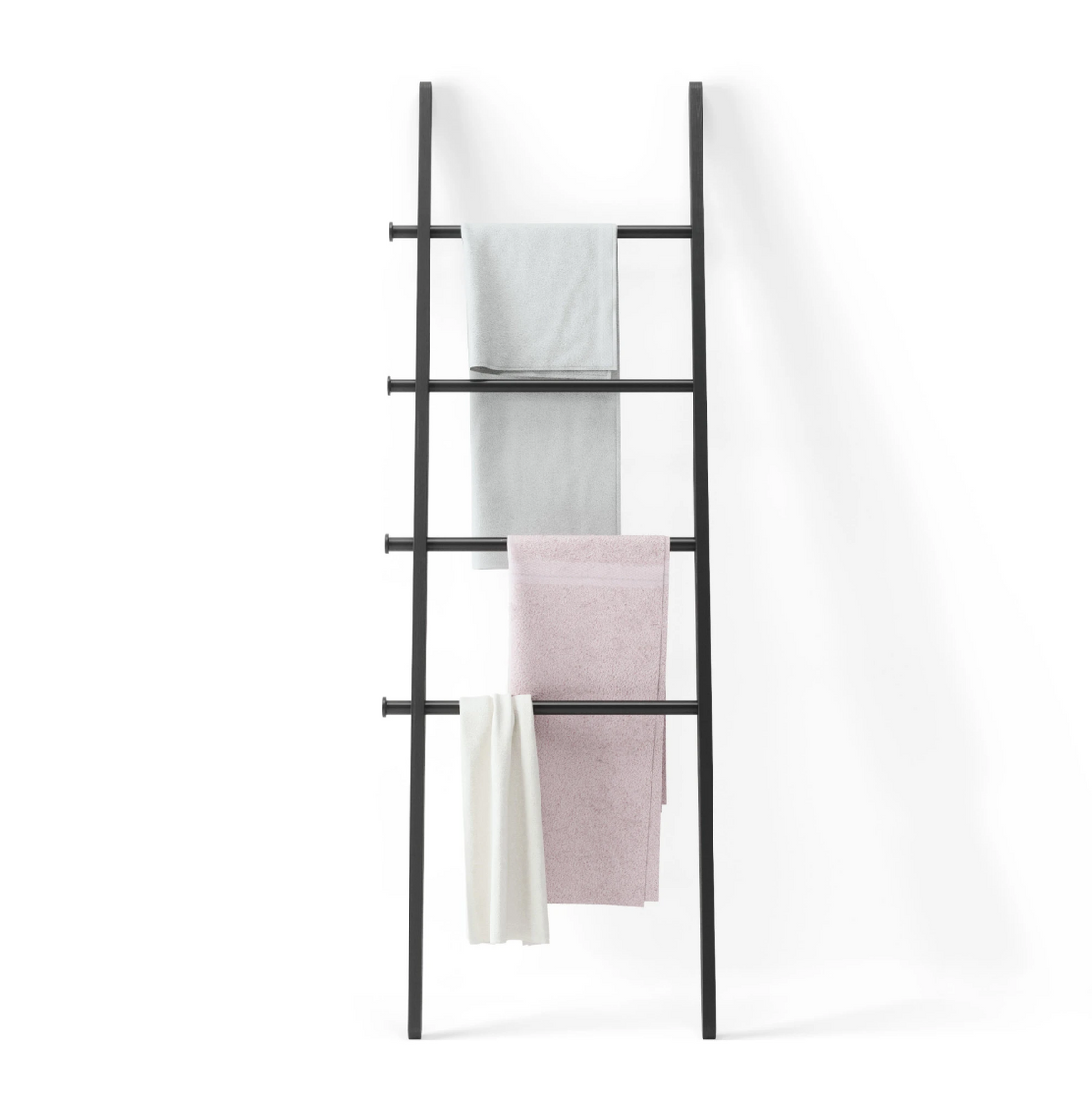 Umbra Leana black wood ladder blanket rack styled in a bedroom corner