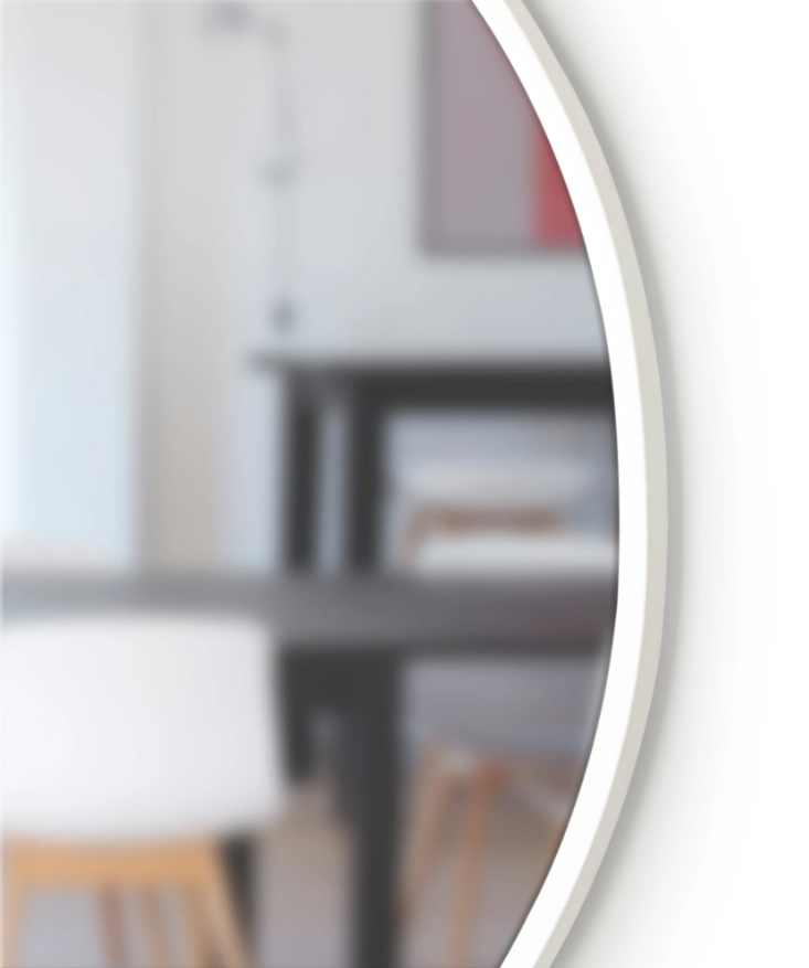 A versatile Umbra HUB WALL MIRROR - White 94cm with a table and chairs in the background.