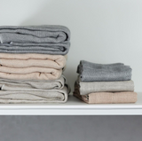 A stack of Nawrap organic face towels on a shelf.