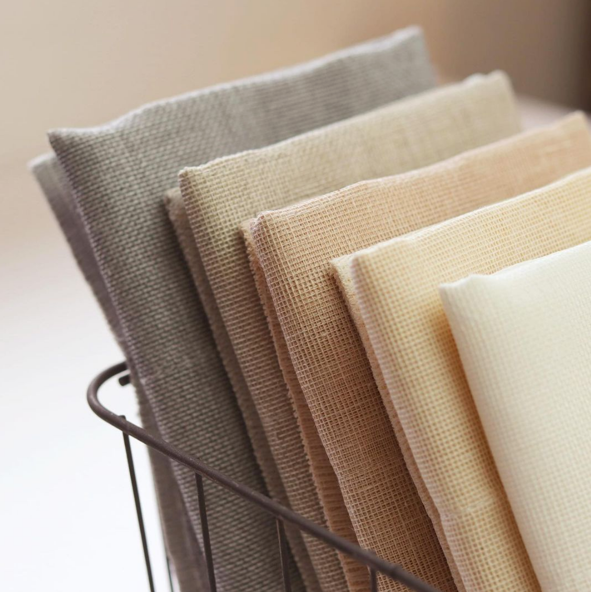 A stack of Nawrap organic face towels in a wire basket.