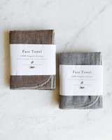 Two ORGANIC FACE TOWELs with the words far travel on them, made by Nawrap.