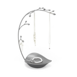 A silver ORCHID JEWELLERY STAND adorned with an assortment of necklaces and bracelets from the Umbra range.
