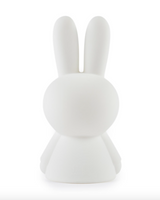 A Miffy First Light Lamp by Mr Maria, a white bunny with an LED module acting as a nightlight, sitting on a white surface.