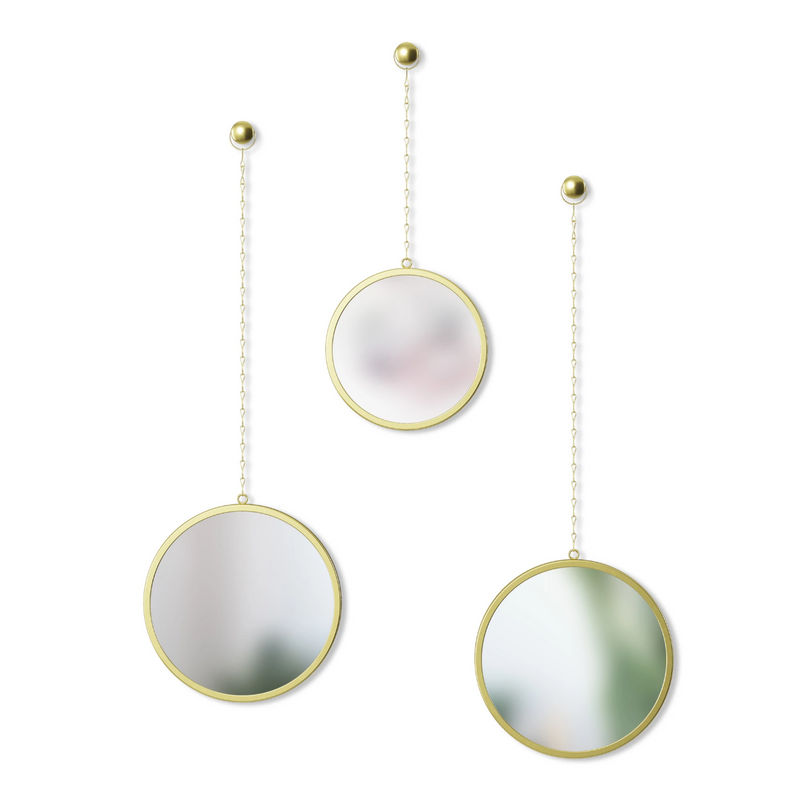 Three DIMA ROUND MIRROR, SET OF THREE mirrors hanging from chains on a white background, supported by hardware. Brand: Umbra.