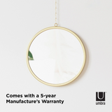 A customizable Umbra DIMA ROUND MIRROR, SET OF THREE hanging on a wall with a 5-year manufacturer's warranty.
