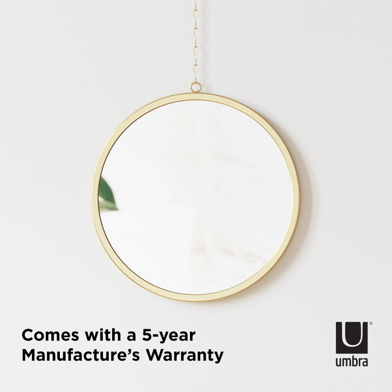 A customizable Umbra DIMA ROUND MIRROR, SET OF THREE hanging on a wall with a 5-year manufacturer's warranty.