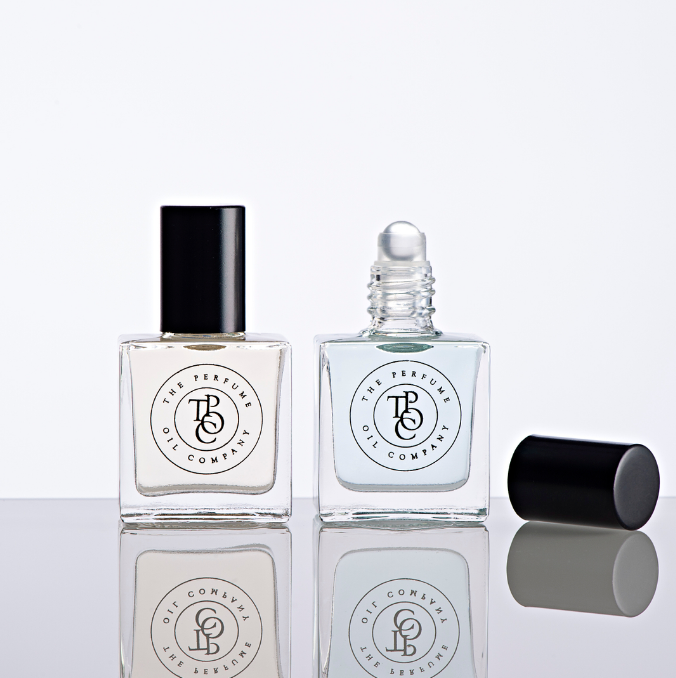 Two bottles of SANTAL perfume oils, inspired by Santal 33 by Le Labo, sitting on a white surface from The Perfume Oil Company.