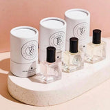 Three bottles of CALYPSO, inspired by Mango Skin (Vilhelm Parfumerie), sitting on top of a pedestal.