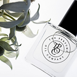 A designer fragrance gift, GYPSY - inspired by Gypsy Water (Byredo) perfume, resting alongside a flower.