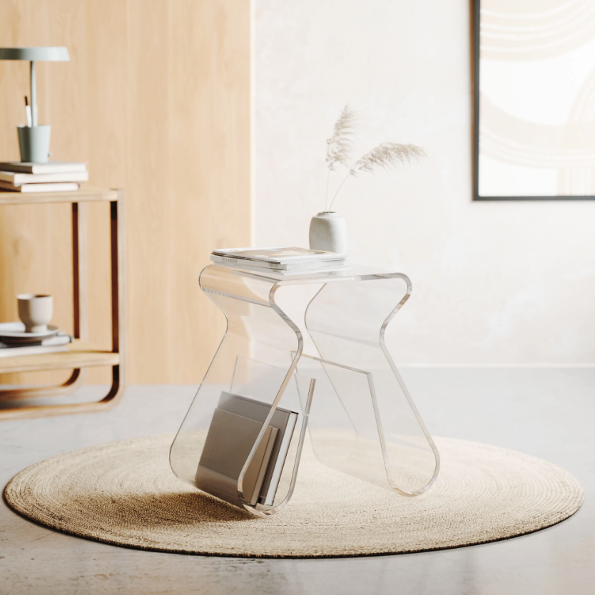 Magino stool on a round jute rug with a book in the rack and a small vase on top
