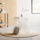 An Umbra Magino Stool With Magazine Rack - Clear Acrylic in a living room.
