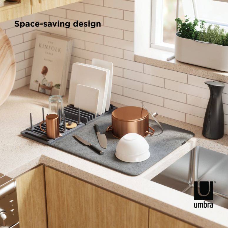 Umbra Udry peg drying rack on a benchtop holding a pot, bowls and boards