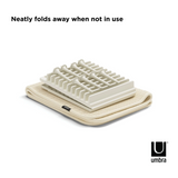 UDRY PEG DRYING RACK WITH MAT, by Umbra, neatly folds away when not in use.