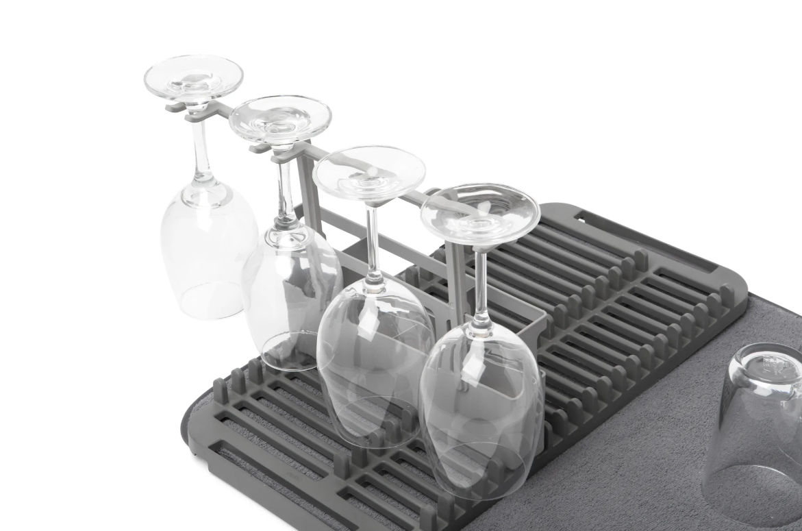 Umbra Udry dish rack holding upturned wine glasses on the grey drying mat