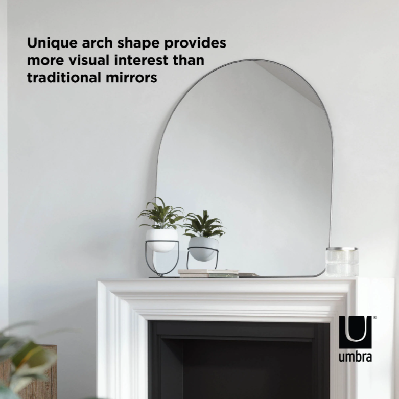Umbra Hubba Arched Mirror in titanium reflecting natural light in a bright room
