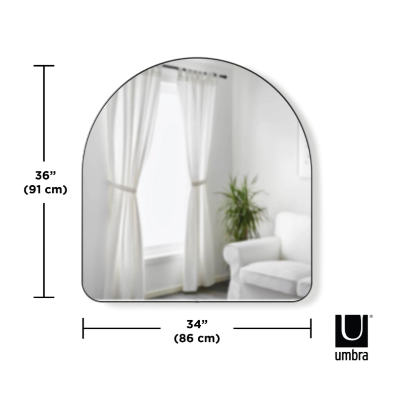 Umbra Hubba Arched Mirror in titanium finish styled in a modern living room