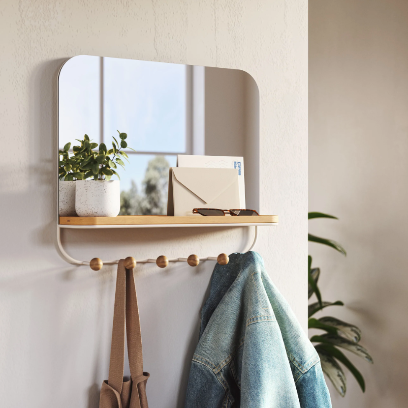 Umbra Estique mirror with hooks and tray styled in an entryway with keys